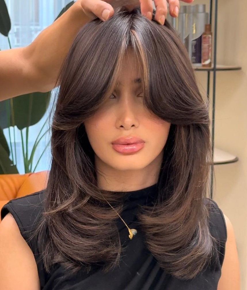 Thick Layered Hair with Cheekbone Length Curtain Bangs