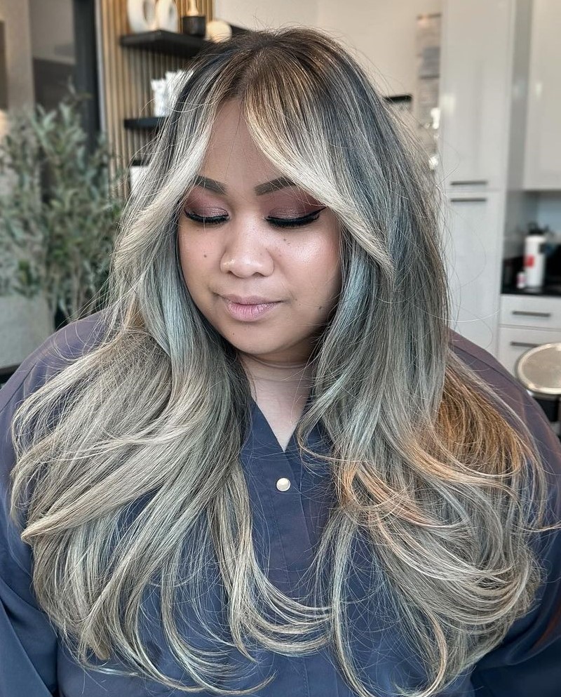 Layered Cut with Curtain Bangs for Round Faces