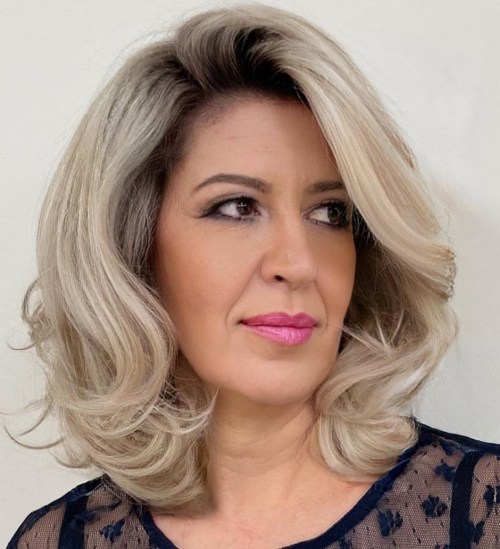 Mid Length Blonde Cut with Darker Roots and Blowout Volume